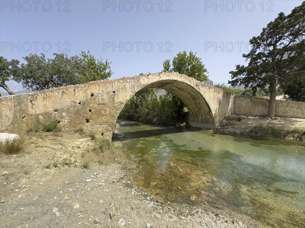 Historic classical stone arch bridge in Venetian architectural style Venetian Great Old Bridge 19th century stone bridge built in 1850 in Ottoman times over the middle reaches of the Megalopotamos River at Preveli, Agios Vasilios, Crete, Greece, Europe