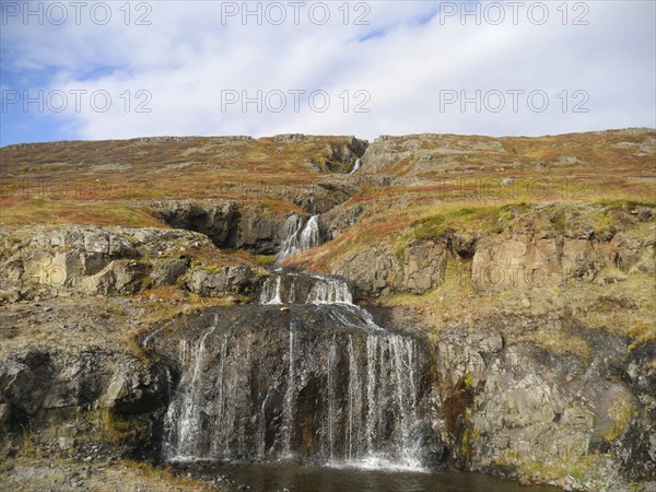 Autumn landscape with waterfall at Isafjordur in the northwest of Iceland