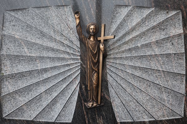 A historic gravestone decoration with a representation of Christ a historic grave stone with a representation of Christ