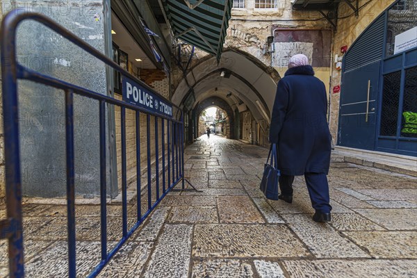 Historic street in the old town of Jerusalem with Police barrier