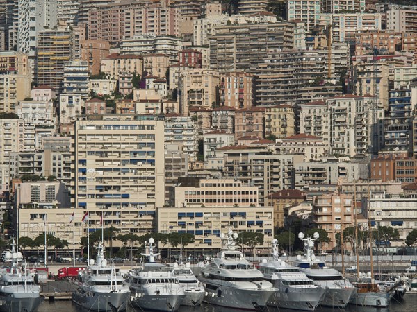 Harbour view with numerous yachts in front of densely packed high-rise buildings, monte carlo, monaco, france