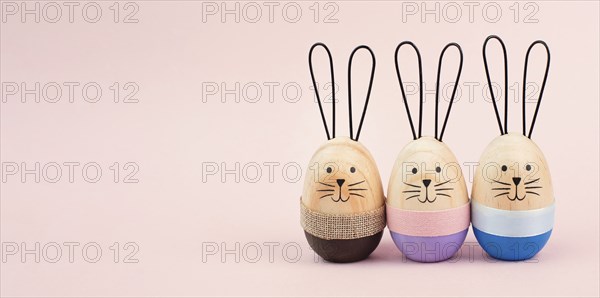 Easter bunny or rabbit group, holiday background and greeting card, painted wooden egg