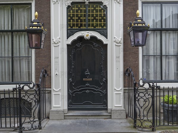 A detailed entrance with ornate doors and lanterns in a historic city building, Delft, Holland, Netherlands