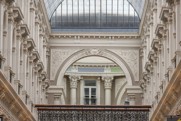 An elegant courtyard with richly decorated walls and a glass roof, looks bright and open, The Hague, Netherlands