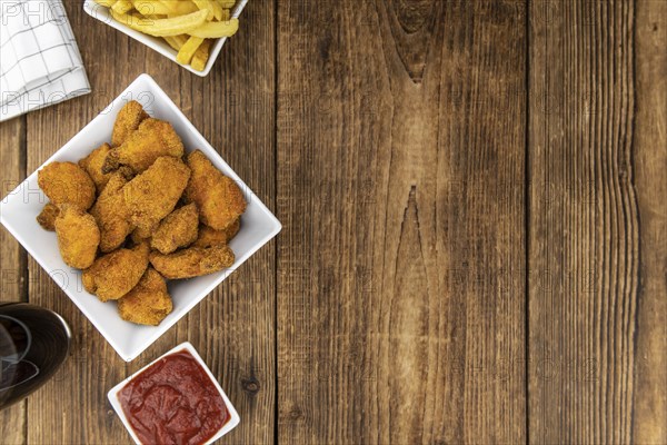 Homemade Chicken Nuggets on vintage background (selective focus, close-up shot)