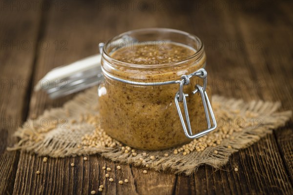 Fresh made German Cuisine (sweet Mustard) on a vintage background (close-up shot)