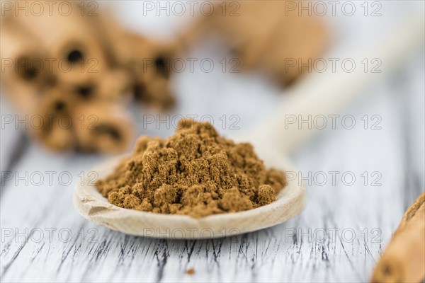 Fresh made Cinnamon Powder on a vintage background (close-up shot)