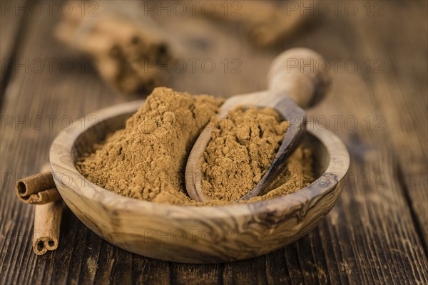 Fresh made Cinnamon Powder on a vintage background (close-up shot)