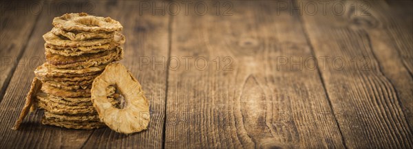 Dried Pineapple Rings on a vintage background as detailed close-up shot, selective focus