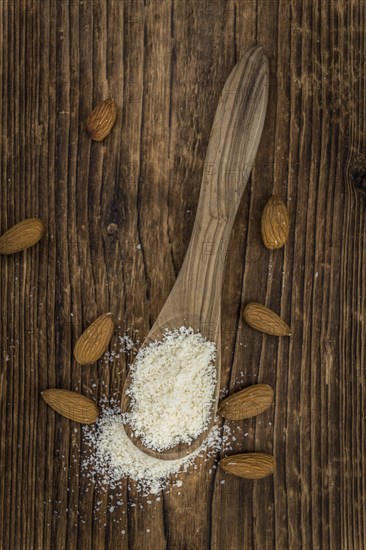 Portion of fresh Powdered Almonds on an old wooden table