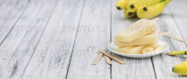 Banana Popsicles on a vintage background (close-up shot, selective focus)