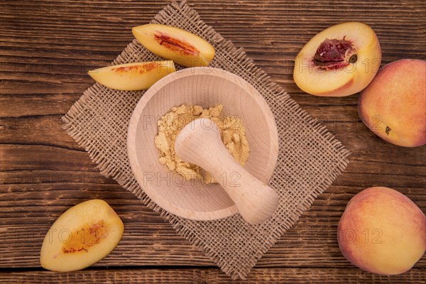 Peach powder on an old wooden table as detailed close-up shot, selective focus