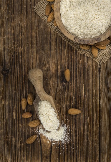Portion of fresh Powdered Almonds on an old wooden table