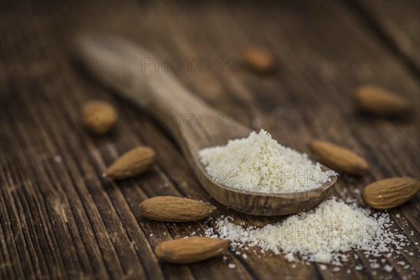 Wooden table with Almond Flour (detailed close-up shot, selective focus)