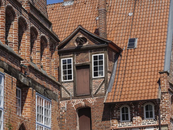 Detail of historic brick architecture with windows and doors in gable arrangement, lüneburg, germany