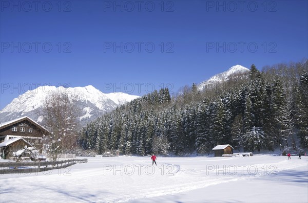 People on cross country ski-run in village