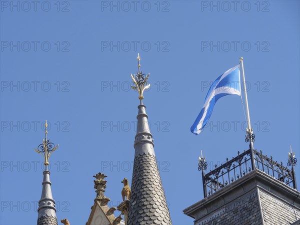 Towers of a building with a Scottish flag on the roof against a clear blue sky, Inverness, Scotland, United Kingdom, Europe