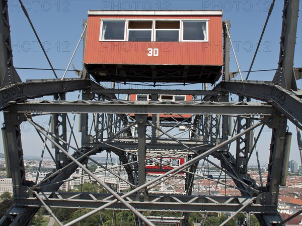 Detailed view of a red cabin of a Ferris wheel with a view of the city in the background, Vienna, Austria, Europe