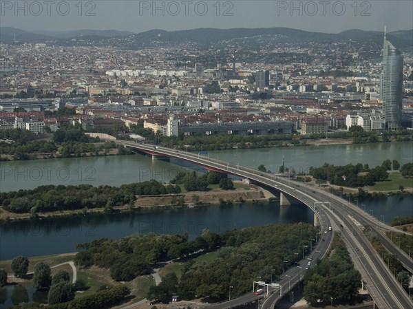 Expansive city view with rivers, bridges and mountains visible in the background, Vienna, Austria, Europe