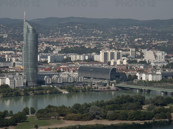 City panorama with skyscraper, bridge and river and surrounding mountain landscape, Vienna, Austria, Europe