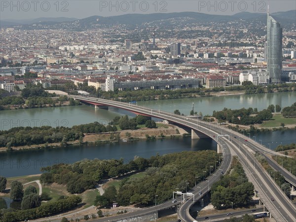 Urban panorama with river, bridge, skyscraper and surrounding landscape, Vienna, Austria, Europe