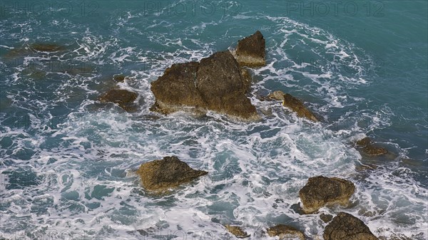 Rocks in the sea, surrounded by spray and surging waves, Atavyros beach, near Monolithos village, Rhodes, Dodecanese, Greek Islands, Greece, Europe
