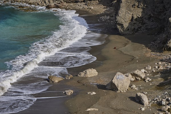 Waves running over a rocky beach shore with sand and water, Atavyros beach, near Monolithos village, Rhodes, Dodecanese, Greek Islands, Greece, Europe