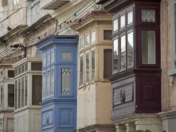 Colourful wooden balconies adorn historic buildings in an old town, valetta, mediterranean sea, malta