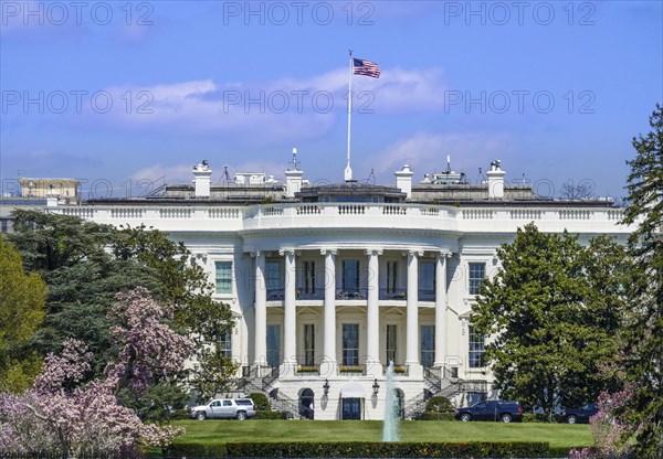 The White House viewed from the South Lawn on a bright spring day in 2018 with visible US flag