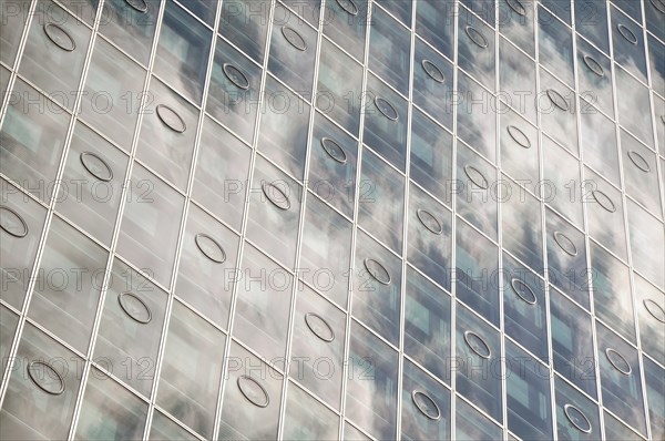 CU of sky reflecting on a modern highrise glas building