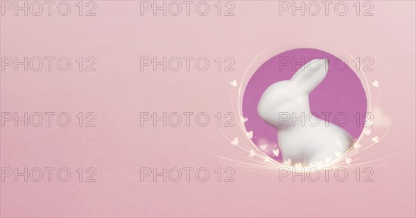 Curious easter bunny or rabbit peeking through a hole, holiday in spring, greeting card with little hearts