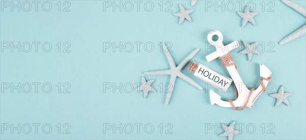 Summer vacation background, anchor, sea stars and a glass bootle with the word holiday, travel and tourism concept