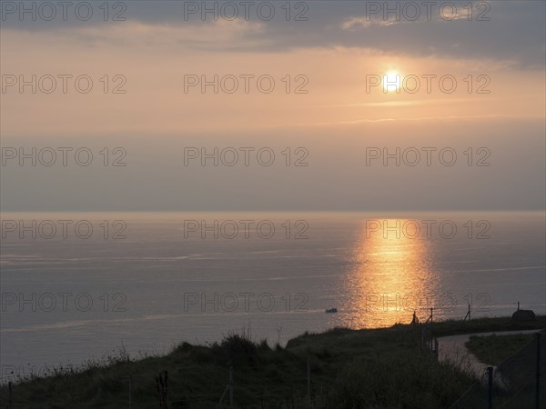 Romantic sunset by the sea with reflecting water surface, Heligoland, North Sea, Germany, Europe
