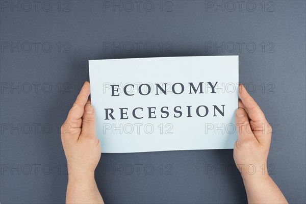 The words economy recession are standing on a paper, inflation and financially crash due to pandemic, stock market and political issue