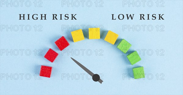 Tachometer high and low risk, pointer is showing to the red risky scale, financial credit and business score