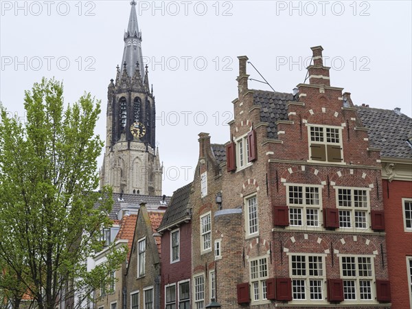 Historic city view with a high church tower in the background and old buildings in the foreground, Delft, Netherlands, Netherlands