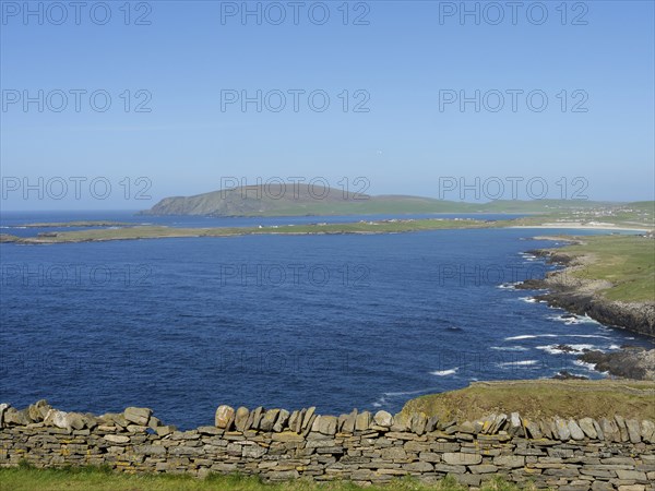 Wide view over the blue sea to hilly islands and a clear sky, lerwick, shetlands, scotland, great britain