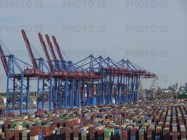 Large container cranes in the harbour, many stacked containers in different colours and ships in the background, Elbe, Hamburg, Northern Germany, Germany, Europe