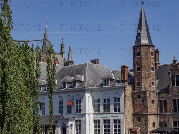 Historic city centre with characteristic architectural towers and brick buildings under a clear sky, Bruges, Flanders, Belgium, Europe
