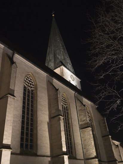 A church tower at night with Gothic architecture and dramatic lighting that emphasises the structure, Borken, Münsterland, North Rhine-Westphalia, Germany, Europe