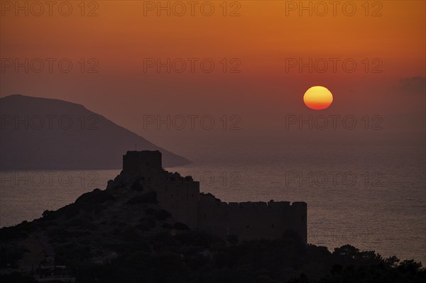 Castle ruins as a silhouette at sunset with a view of the sea and mountains, dark sky, Kritinia Castle, St John's Castle, Kritinia, Rhodes, Dodecanese, Greek Islands, Greece, Europe