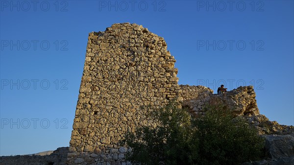 An old, ruined stone tower on a rock under a clear sky, Kritinia Castle, St John's Castle, Kritinia, Rhodes, Dodecanese, Greek Islands, Greece, Europe