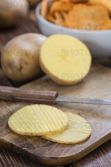 Rippled Potato Chips (selective focus) on an vintage wooden table