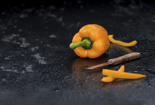 Slate slab with Orange paprika (selective focus, close-up shot)