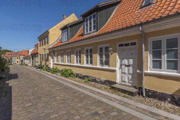 Old town of Rudkobing, renovated houses, colourful row of houses, dormers, decorative design, plants, traffic-free street with cobblestones, Langeland island, Sydfyn, South Funen, Baltic Sea, Danish South Sea, Denmark, Europe