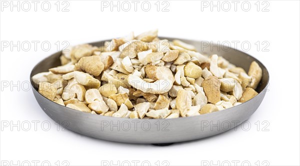 Portion of chopped Cashew nuts isolated on pure white background (detailed close-up shot)