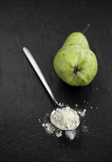 Portion of fresh made Pear powder on a slate slab (selective focus)