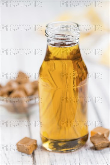 Portion of fresh Caramel Sirup (close-up shot, selective focus)
