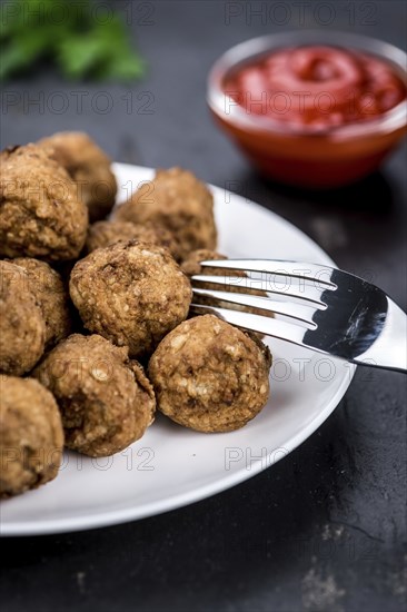 Slate slab with homemade Meatballs (selective focus, close-up shot)