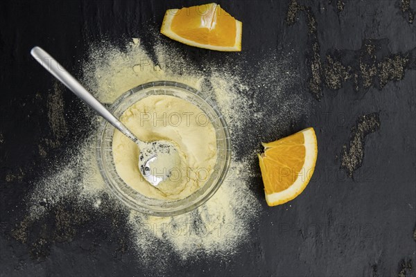 Fresh made Orange fruit Powder as detailed close-up shot (selective focus)